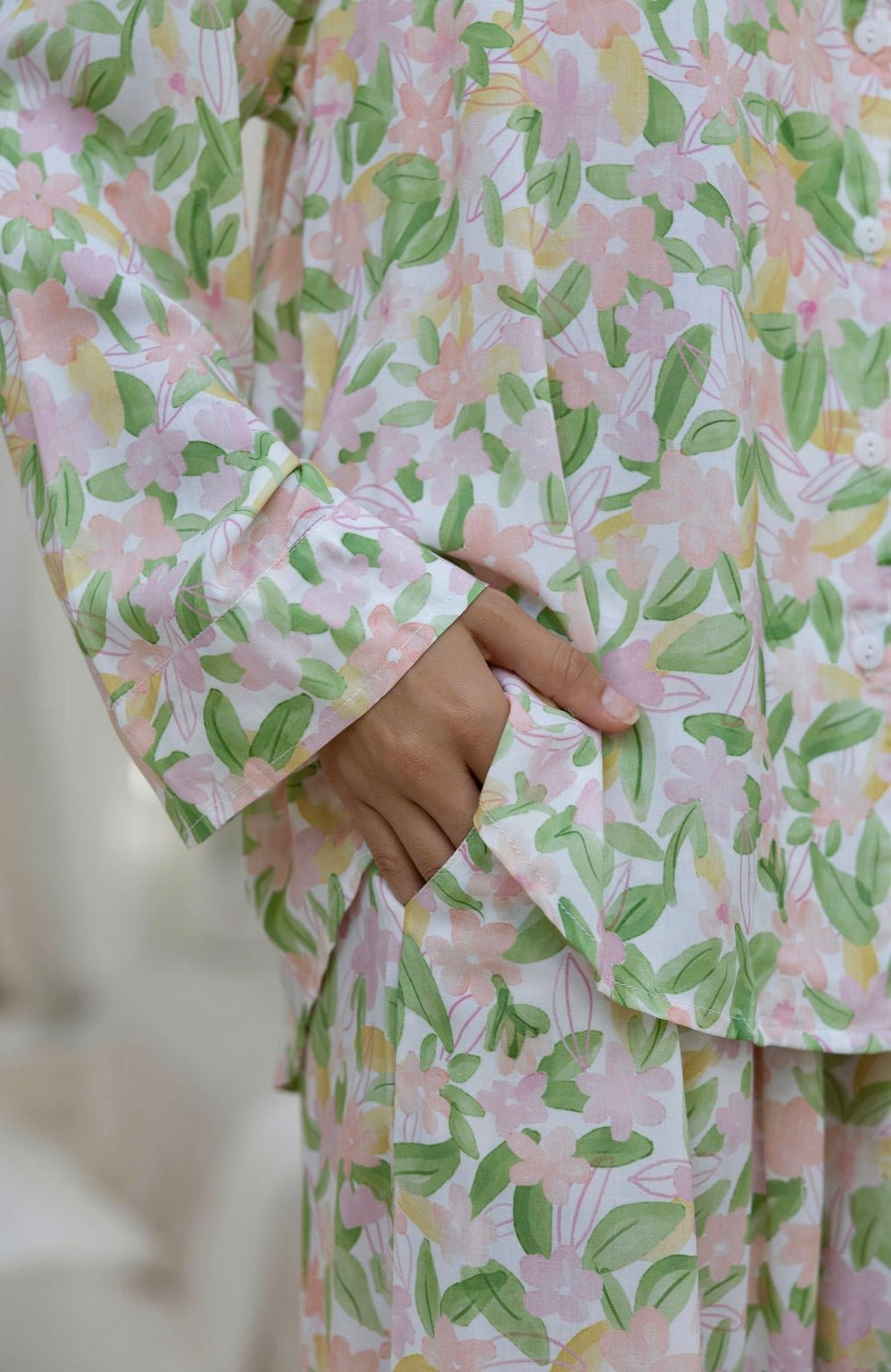 Women’s long pyjama set in soft floral print with button-up top and relaxed pants - close-up