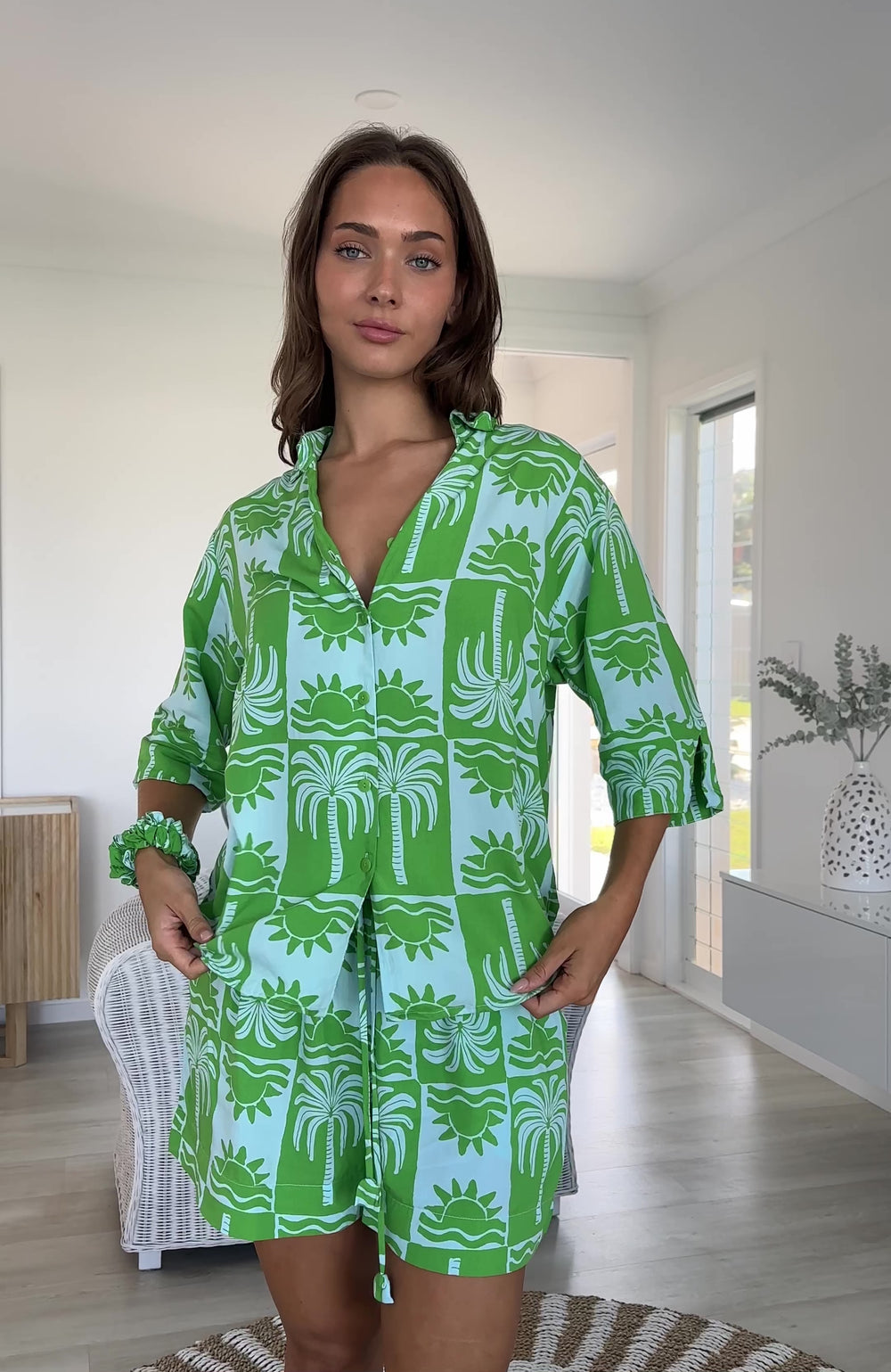 Palm green and light blue palm tree print two-piece pyjama set with shirt and shorts, worn as resort wear, video